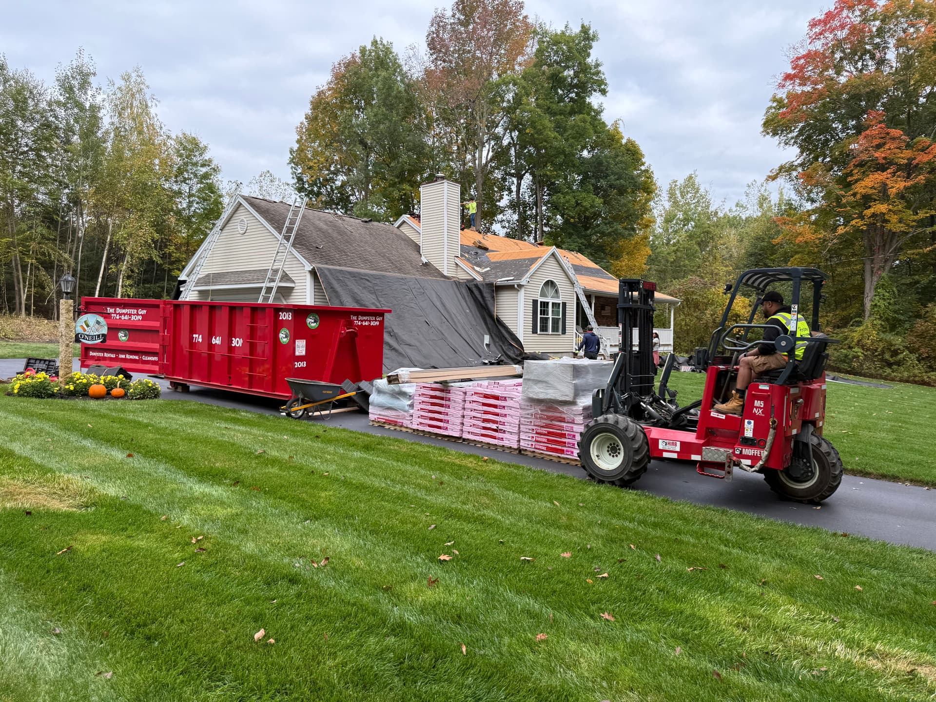 Professional roof replacement with IKO Dynasty shingles on modern house
